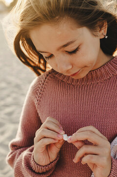 Girl wearing knitted sweater at beach