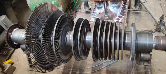 Disassembled steam turbine in the process of repairing and electric generator at power plant © alexrow