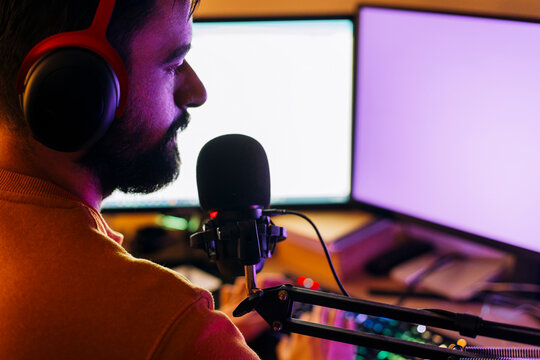 Gaming influencer doing live stream and playing video games on computer at home