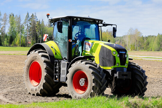 Claas Axion 850 tractor in field on a sunny day of spring. 