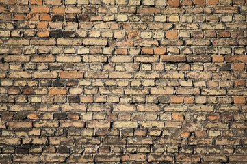 in the photo there is an old brick wall close up