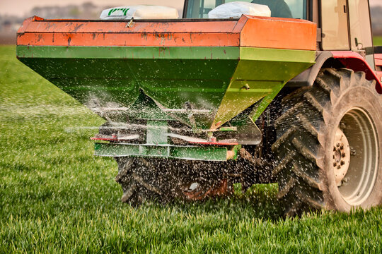 Crop sprayer spraying fertilizer on field