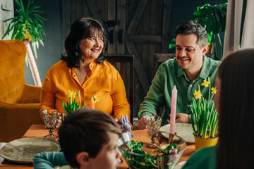 Happy family celebrating Easter dinner at dining table in home