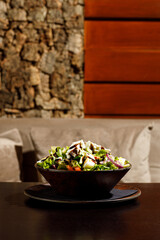 Mixed healthy salat served in wooden plate on background