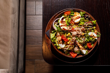 Mixed healthy salat served in wooden plate on background