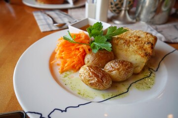 Fried fish with potato at local restaurant in Norway, Europe.