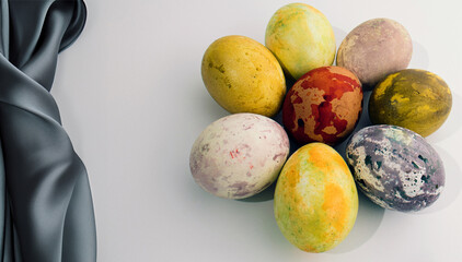 Colorful Easter eggs on white background with grey silk. Minimal creative Easter composition.