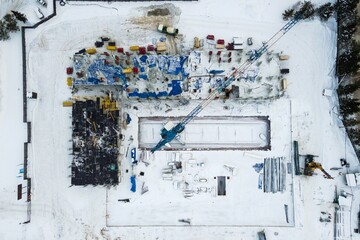 the construction site of an apartment building in the winter from a height