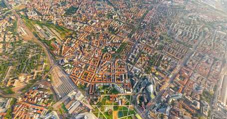 Milan, Italy. Botanical garden and skyscrapers. Panorama of the central part of the city. Summer day with clouds. Aerial view