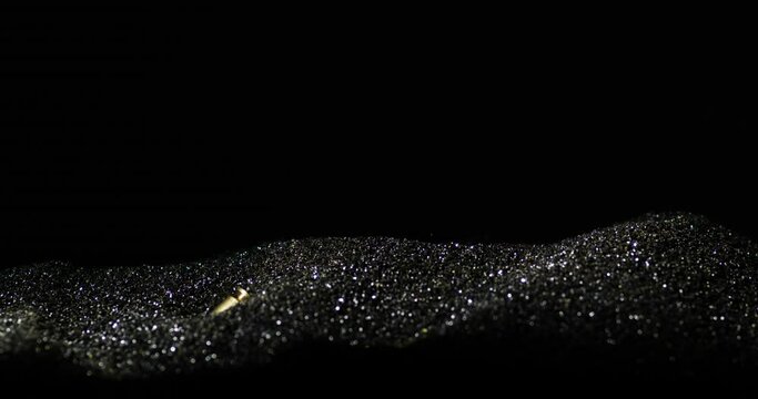 9mm Parabellum Firearm Cartridges Sink Into The Gun Powder. - close up shot