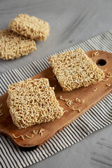 Dry Ramen Noodles on a wooden board, side view.