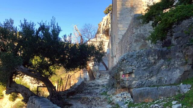 Old stone building with rough stone block stairs. Historic ruins. Pustinja Blaca Monastery. Brac Island, Croatia. Europe.