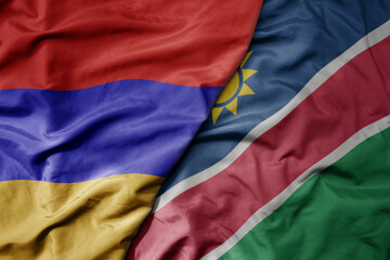 big waving national colorful flag of namibia and national flag of armenia .