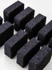 set of black sponges for washing dishes on a white background
