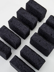 set of black sponges for washing dishes on a white background