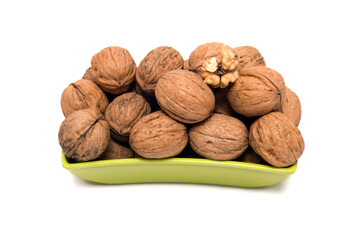 Fresh, Uncracked Walnuts Nestled in a Vibrant Green Bowl, This image beautifully captures fresh, uncracked walnuts nestled in a sleek, vibrant green bowl. The earthy brown tones of the walnuts