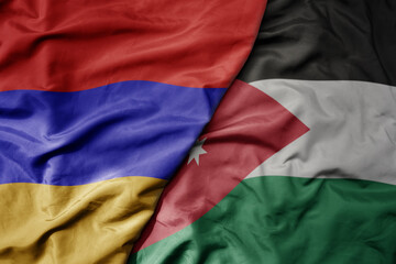 big waving national colorful flag of jordan and national flag of armenia .