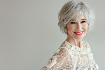beautiful elderly woman model with beautiful gray hair smiling in the studio isolated on background. copy space
