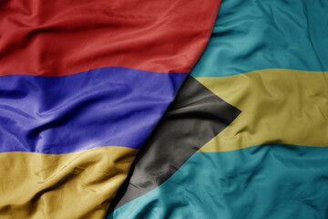 big waving national colorful flag of bahamas and national flag of armenia .