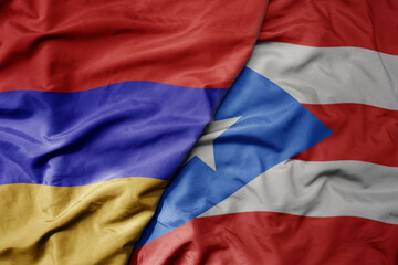 big waving national colorful flag of puerto rico and national flag of armenia .