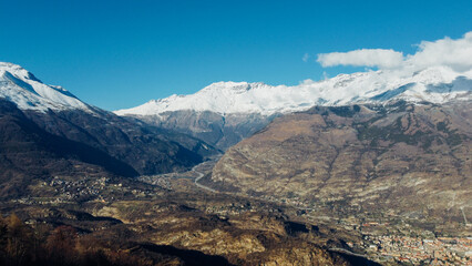 Fototapeta premium Aerial view of winter landscape with mountain peaks covered with snow in the italian Alps. Natural background.