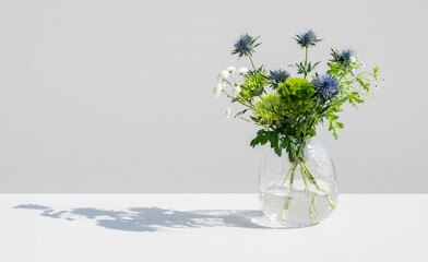 fresh flowers in vase on neutral background negative space