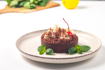 Delicious chocolate tart garnish with cherry and mint. Classic dessert. - 745728508