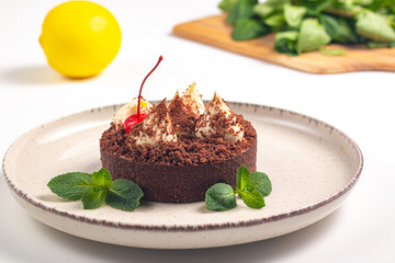 Delicious chocolate tart garnish with cherry and mint. Classic dessert. - 745728526