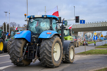 Farmers protest in Wroclaw, Poland. Protesting farmers on tractors block traffic on city streets. Demonstration of agricultural workers - obrazy, fototapety, plakaty