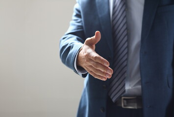 Businessman offer hand to shake as hello in office closeup