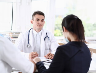 Fototapeta premium Male family doctor listen carefully young