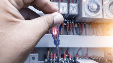 Checking the electrical power on the control panel using a test pen, a repair concept in electrical...