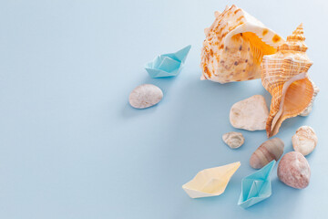 summer sea background with paper boats, stones and seashell