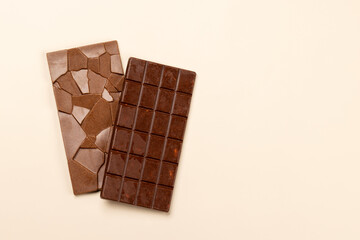Chocolate bars on beige background