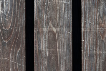 Old wooden boards with worn varnish and black stripes as background