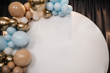 Photo wall decoration of blue, brown, and gold balloons in hall restaurant. Trendy decor. Celebration baptism concept. Birthday decor for a baby boy or girl party on white background. Details closeup.