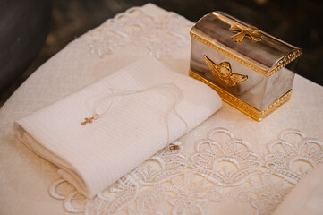 Accessory for christening. Church accessories for the baptism of a newborn baby. Accessories for the priest's service are made of gold closeup. Side view. Sacrament of baptism.