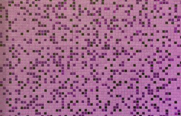 The texture of the wall, decorated with a mosaic of various small square tiles. Abstract pattern of ceramic tiles on the wall
