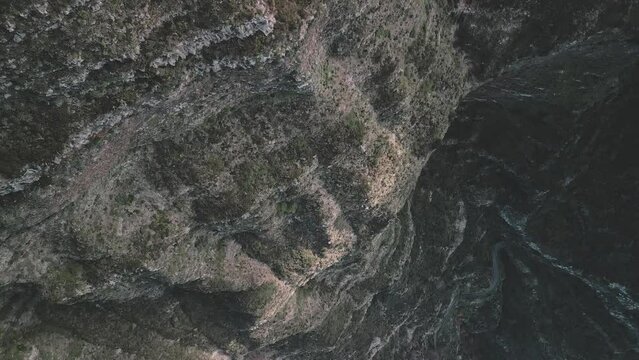 Drone flight over a cliff with camera looking downwards moving towards the town of Curral das Freiras, Madeira 02