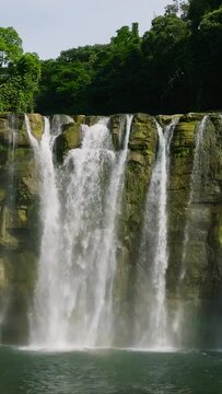 Tinuy-an Falls with white curtain-like and mist. Bislig, Surigao del Sur. Philippines. Slow motion. Vertical view.