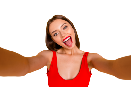 Close up portrait of emotional girl taking selfie shot, grimacing makes memories at holiday and for her blog isolated on bright yellow background - Powered by Adobe