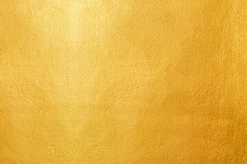 Gold wall texture background. Yellow shiny gold paint on wall surface with light reflection,...