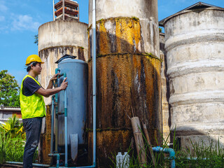 Asian man engineer controlling the quality of water places operating industrial water purification...