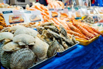 Fresh seafood selling at Kuromon Ichiba in Osaka Japan. The Kuromon Ichiba is a spacious market with vendors selling street food, fresh produce and shellfish, plus souvenirs, Seafood in Kuromon Market