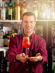 Bartender presenting cocktail at bar - 745773716