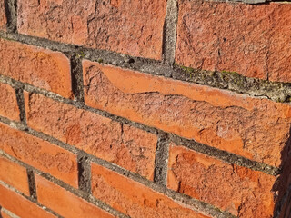 a wall of old crumbling red bricks