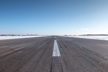 Empty airport runway on a clear cold winter day