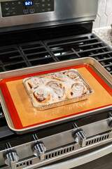Freshly Baked Cinnamon Rolls Cooling on Stove Top