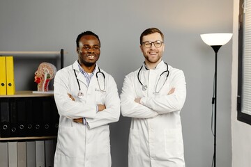 Two men in white lab coats standing together