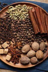 Different spices and nuts on table, top view